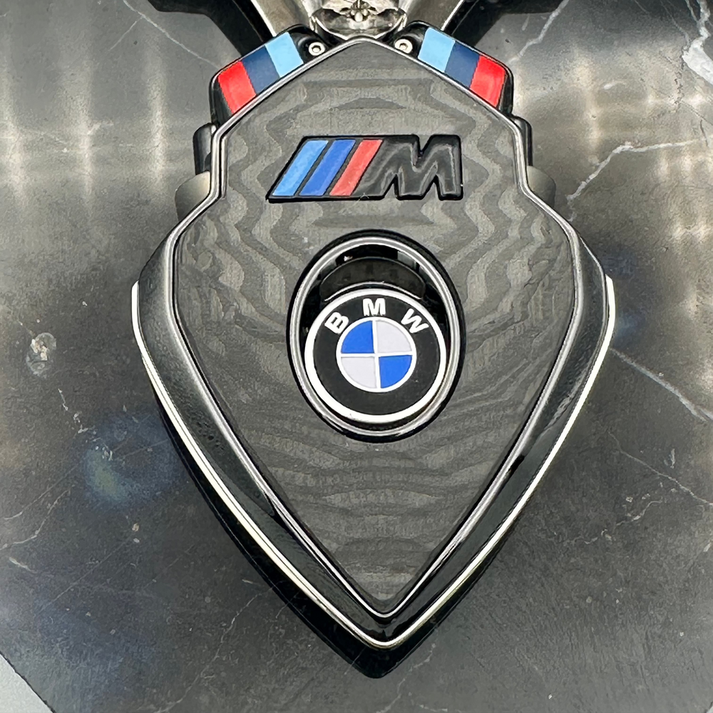 M Series charging case with carbon fiber cover, cast M logo and BMW roundel