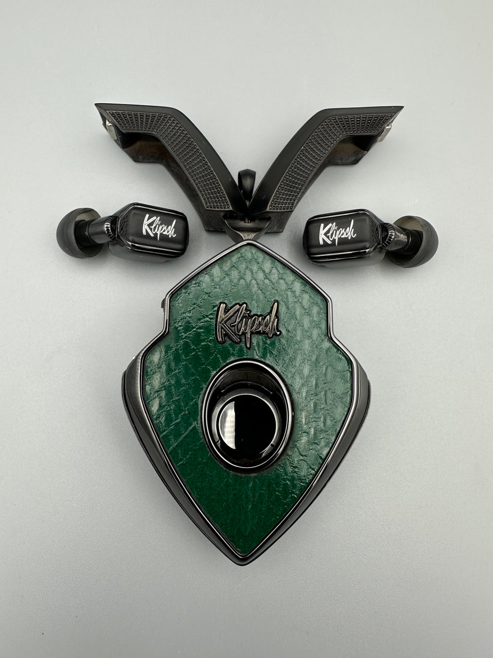 Sea Snake green snakeskin charging case with black doors open and black earbuds