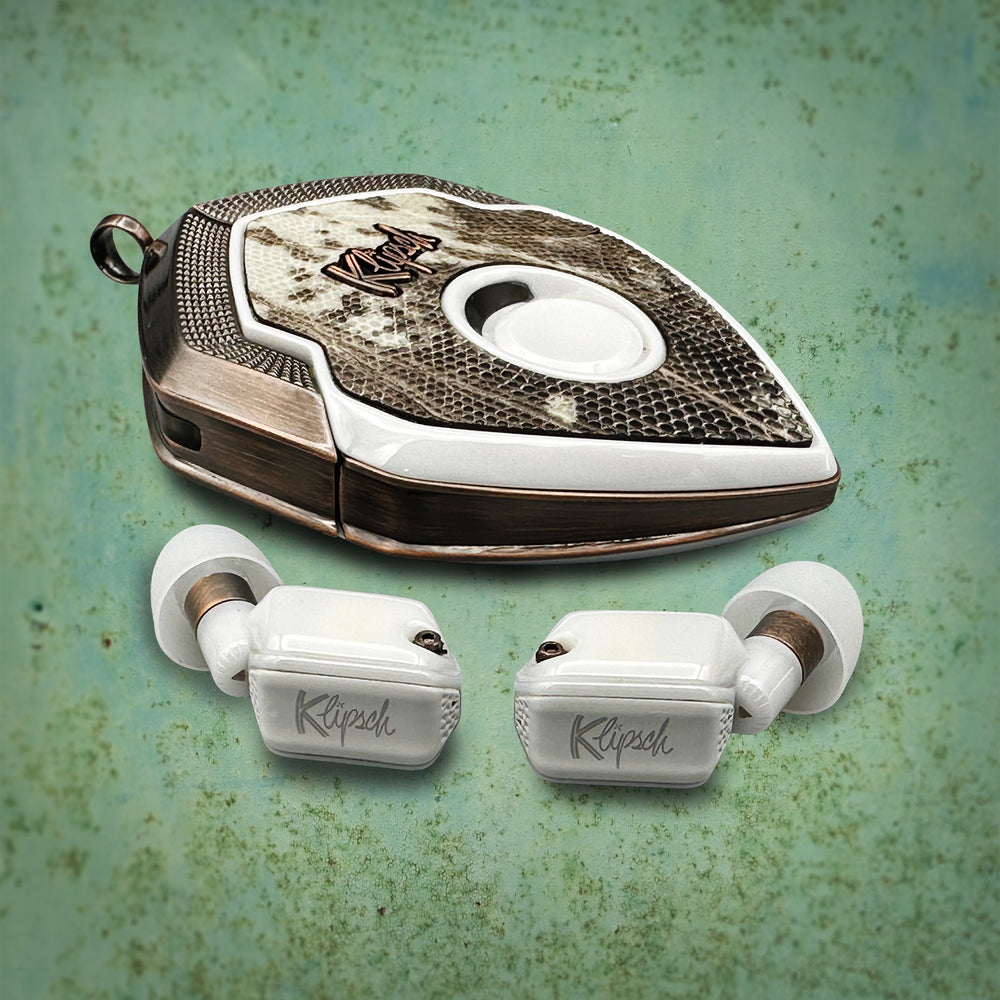 Mint Cocoa Lizard case with aged copper frame and lizard skin cover beside white earbuds