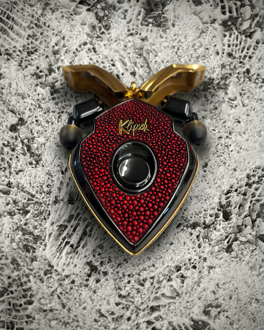 Golden Stingray Filigree red stingray charging case with gold doors open and black earbuds