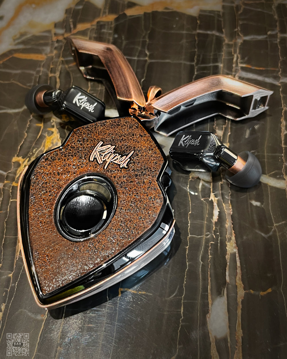 Terra charging case with distressed brown leather, antiqued copper doors, and black earbuds